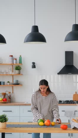 woman preparing fruits and vegetables in a modern kitchen