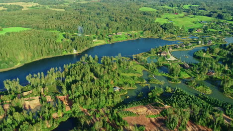 High-angle-drone-panning-view-of-the-green-nature-of-Amatciems-in-Latvia