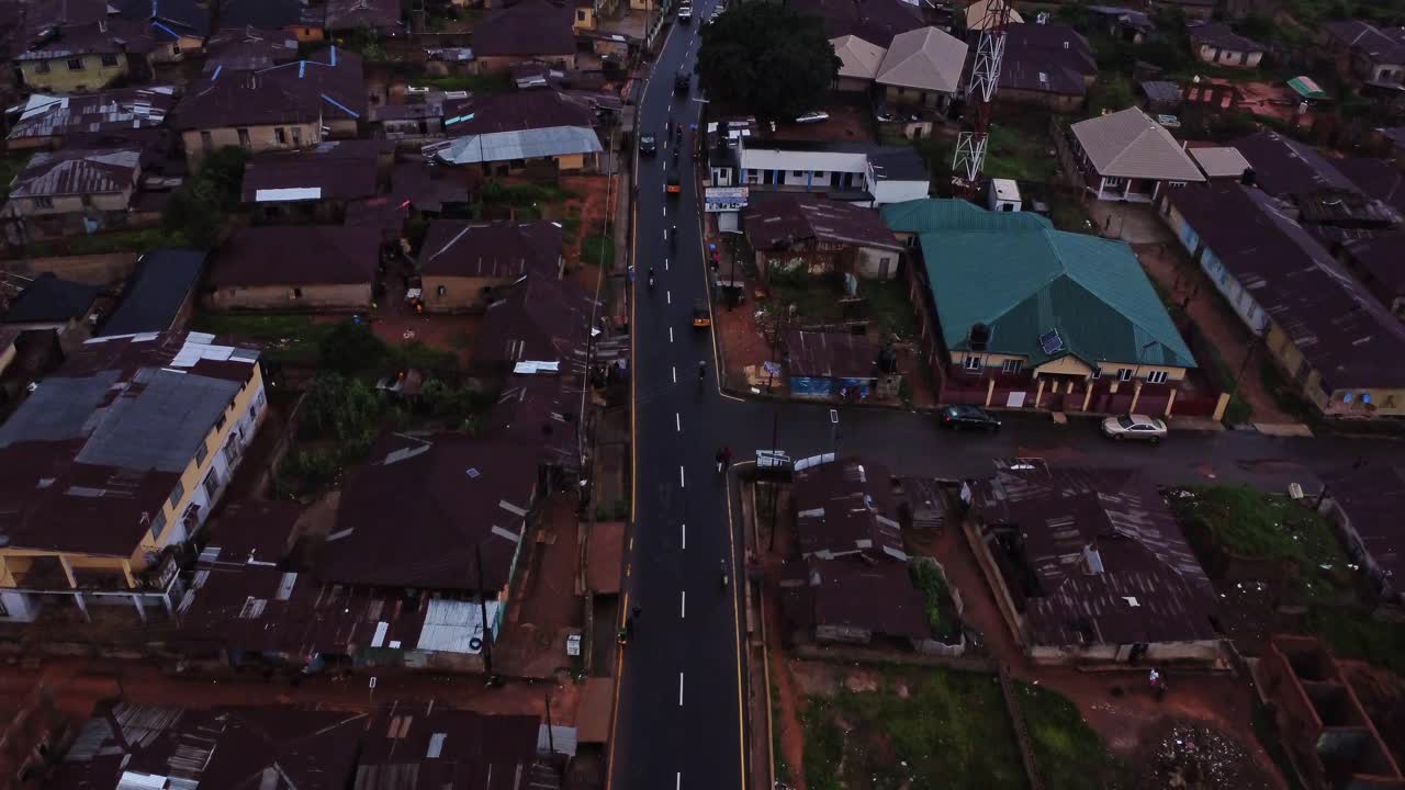 Drone flying over a busy road in a suburban neighborhood in Nigeria, Africa
