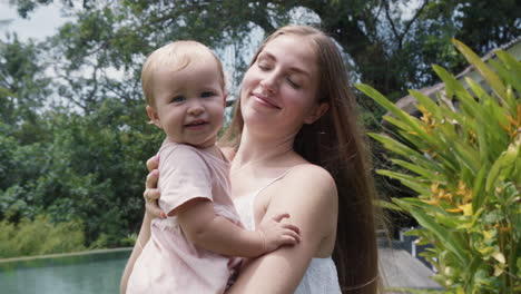 hija bebé y madre en el verde