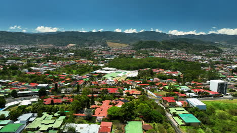 aerial view rising over the vibrant cityscape of san jose, sunny day in costa rica