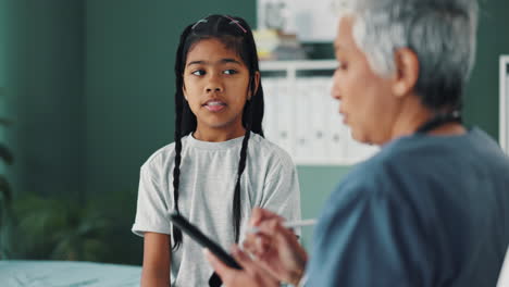 a doctor consulting with a young patient in a clinic