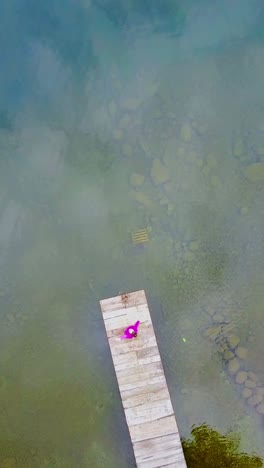 woman on a wooden pier over water