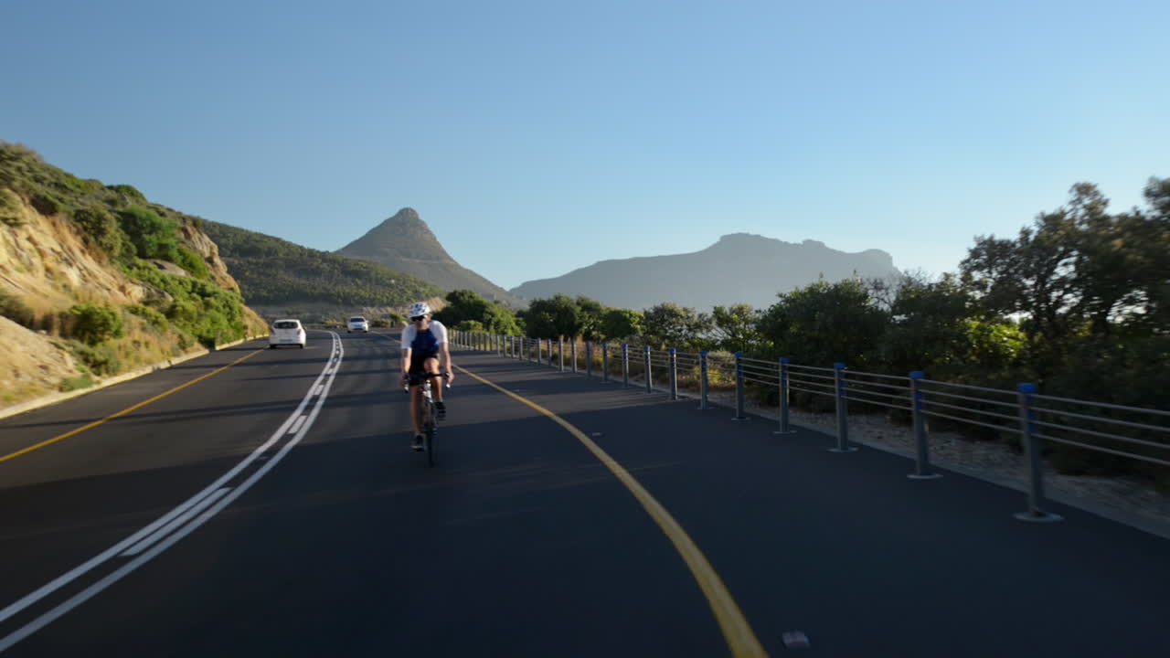 Healthy man cycling road bicycle outdoors fitness steadicam shot