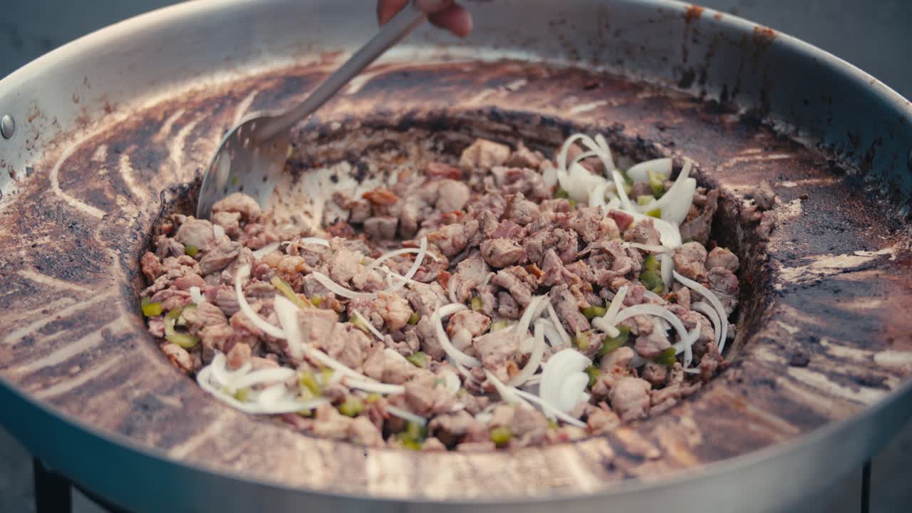 Discada regia, a Mexican food dish, being cooked in slow motion