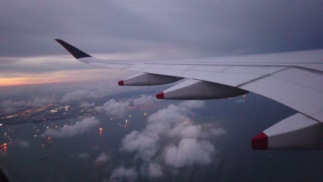 wing of aircraft flying above the clouds