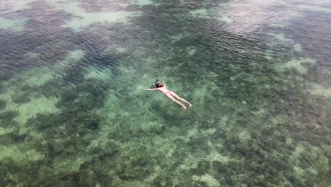 aerial view of female snorkelling in waters at koh lipe