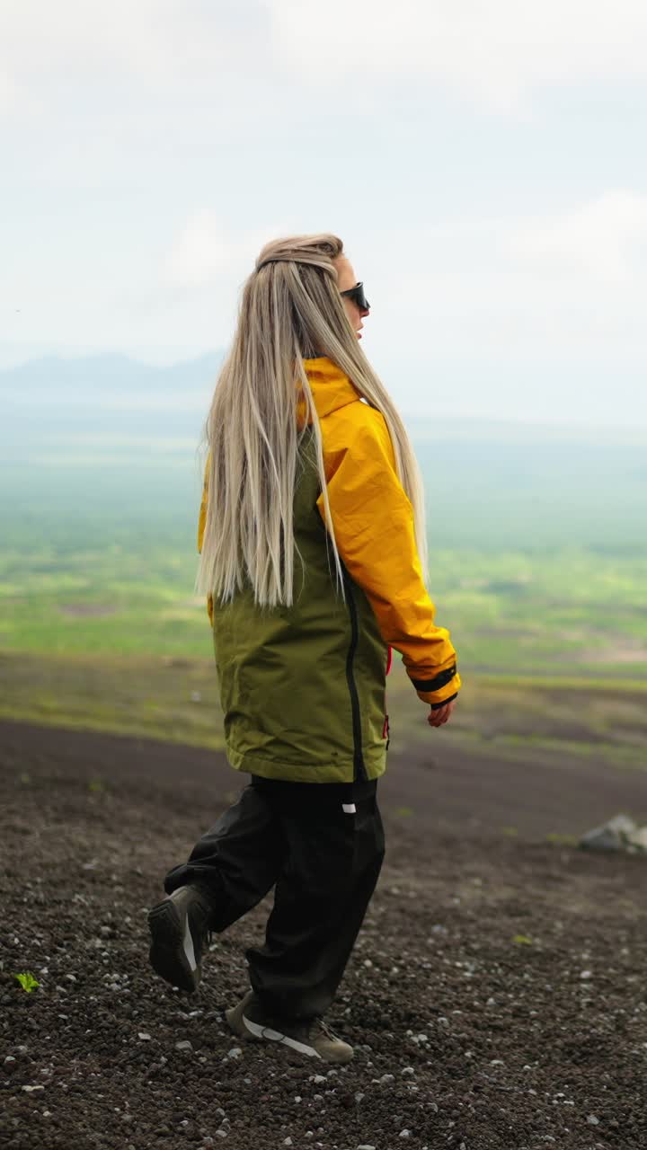Adventurous Woman Standing on Volcanic Mountain Terrain