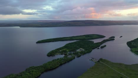 Lusty-Beg-Island-during-colorful-sunset-in-Northern-Ireland,-high-backwards-aerial
