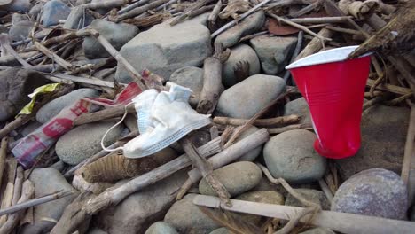 plastic garbage and dirty waste on beach. disposable face mask. ecological waste problem