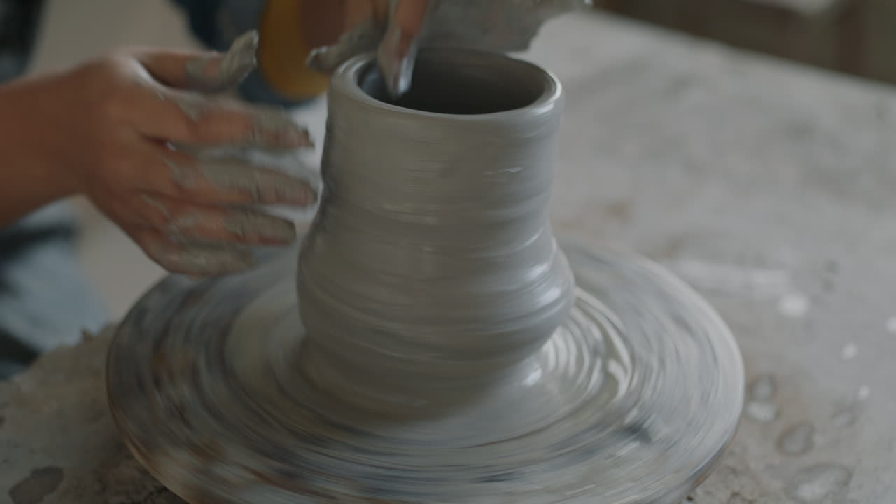 Person Shaping Pottery on a Wheel