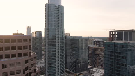 aerial tracking shot of downtown austin, texas skyscrapers at sunset