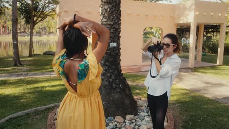 woman photographer capturing a model in a tropical garden