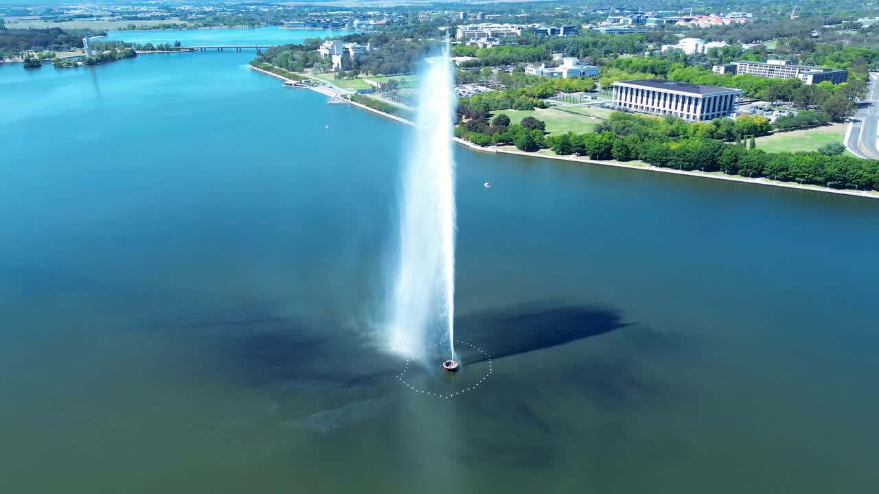 Drone aerial landscape of water jet spraying Captain James Cook Memorial fountain sculpture in Lake Burley Griffin Canberra ACT Australia travel tourism landmark boating fishing