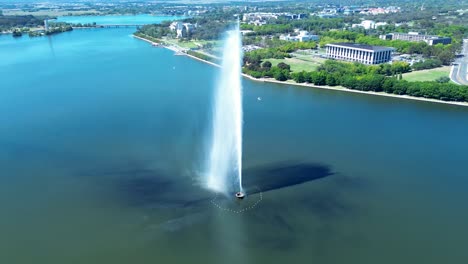 drone aerial landscape of water jet spraying captain james cook memorial fountain sculpture in lake burley griffin canberra act australia travel tourism landmark boating fishing