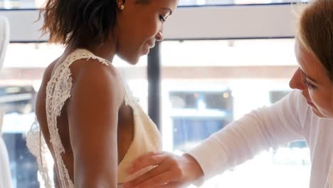female fashion designer taking measure of woman