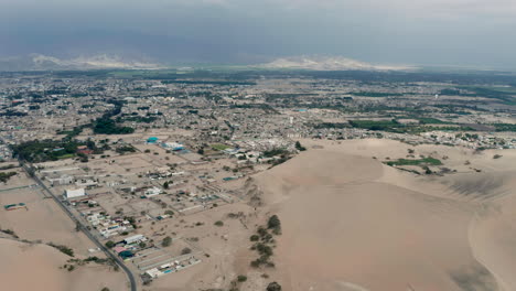 Aerial-dolly-shot-showing-the-landscape-above-the-city-of-Ica,-in-southern-Peru-in-bright-daylight