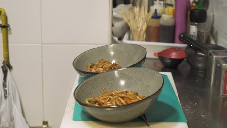 preparing noodles in a wok
