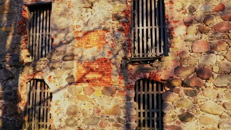 antique medieval castle with steel bars on windows in close up view