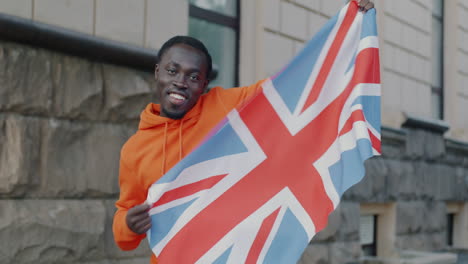 man proudly displaying british flag
