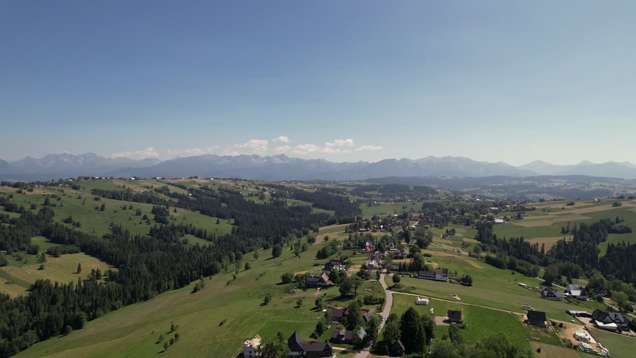 Aerial View of Polish Tatra Mountains and Rolling Hills on Sunny Day