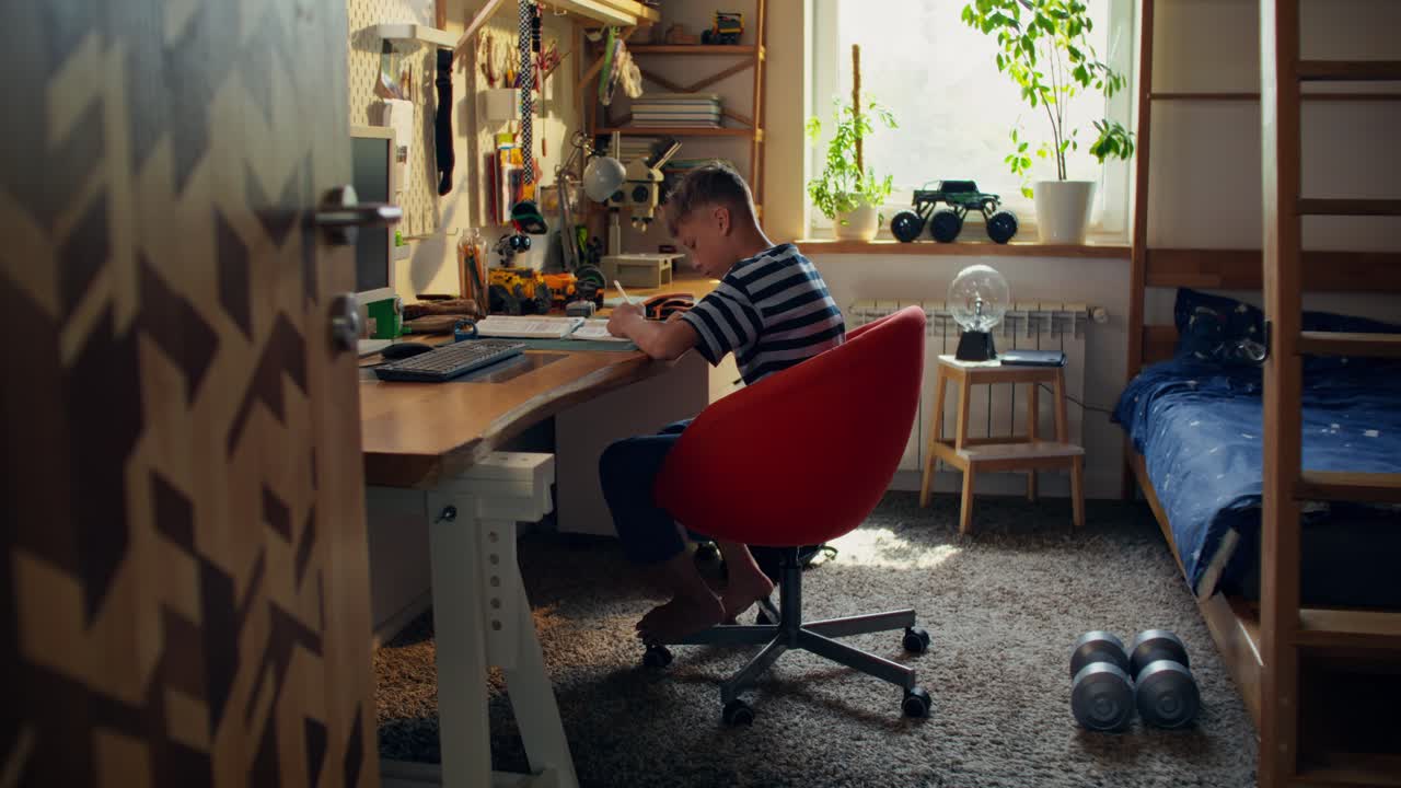 Boy Doing Homework in His Bedroom