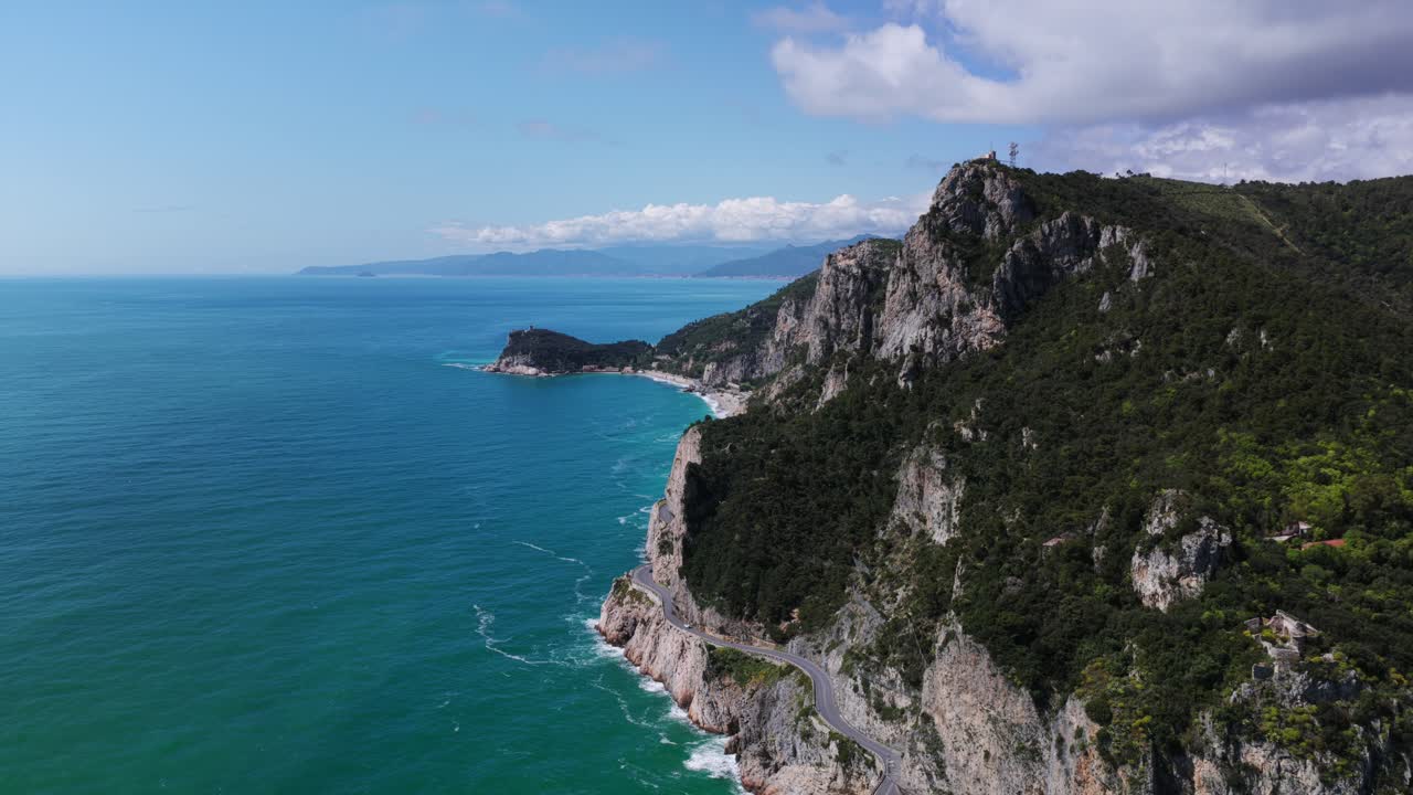 Breathtaking rocky cliffs and vibrant turquoise waters of Ligurian Sea near Noli, Italy, ideal for nature and travel promos. Aerial drone backward, copy space