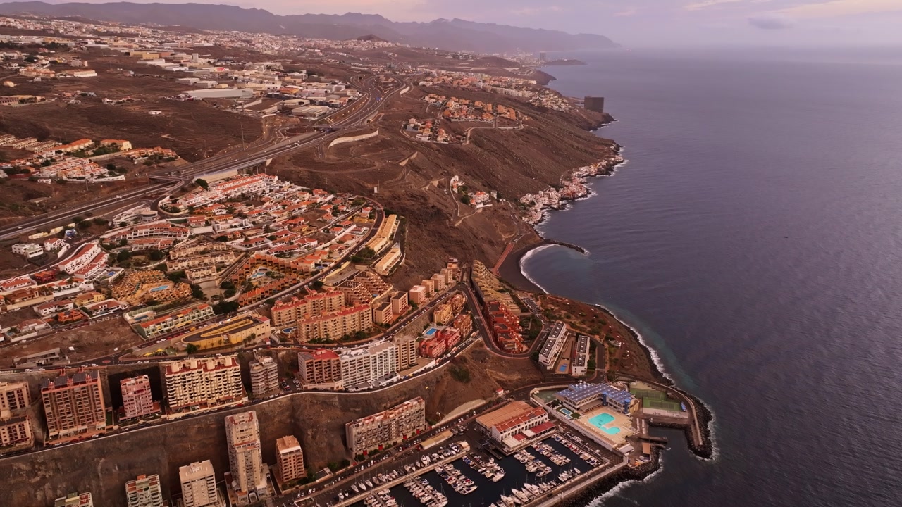 Drone footage of Radazul coastal town and Atlantic Ocean horizon at sunset Spain