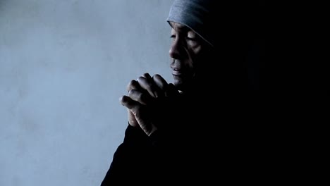 man-praying-to-god-with-hands-together-Caribbean-man-praying-with-grey-background-stock-video-stock-footage