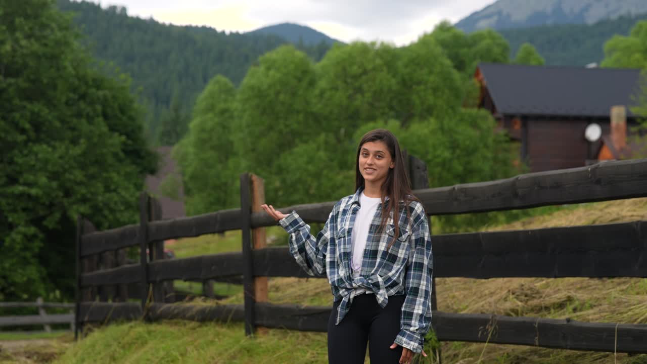 산 속 의 오두막 앞 에서 몸짓 을 하는 여자