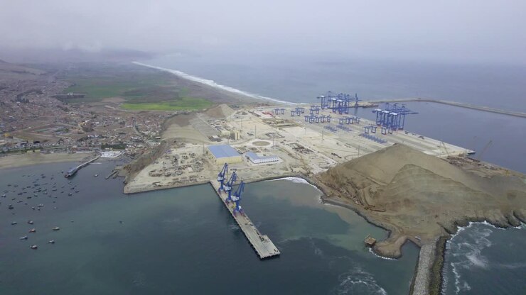 Aerial view of a coastal port with cranes and infrastructure