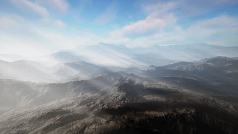 stunning aerial view of mountain range with fog and sun rays