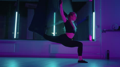 aeroyoga training in fitness club woman is doing exercise for stretching in hammock