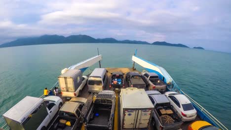 cars loaded on a ferry and headed for the island koh chang trat province of thailand