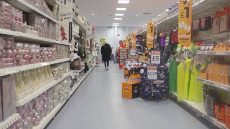 woman browsing store looking through halloween decorations. handheld