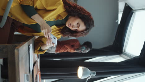 Young-Woman-Using-Smartphone-during-Office-Workday