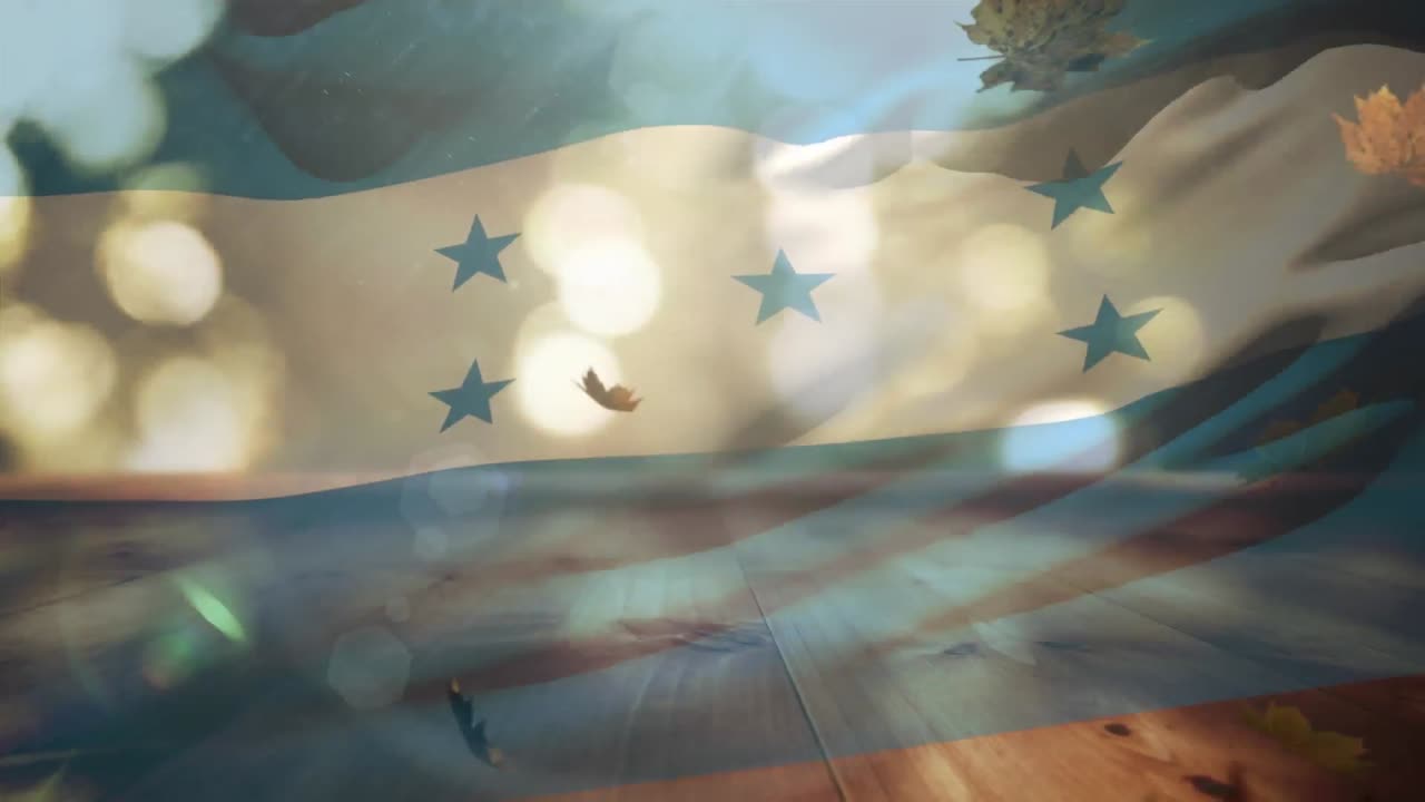 Composizione digitale di bandiera dell'Honduras sventolante su foglie autunnali che cadono sopra una superficie di legno.