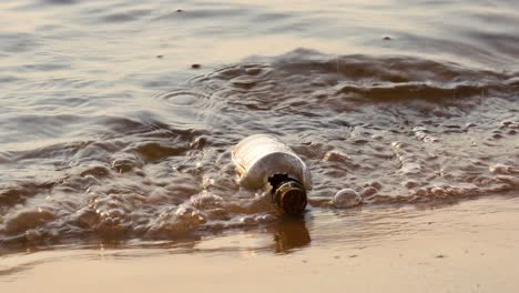 Message-in-the-bottle-against-the-Sun-setting-down