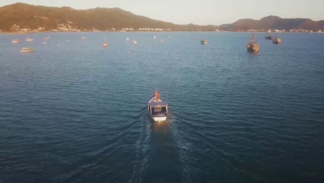 aerial view over the coastline of florianopolis, croatia. boat arriving into the bay