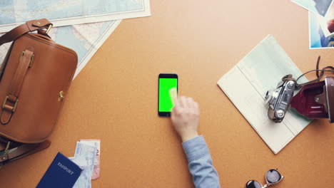 Top-view-woman-traveler-hands-planning-holiday-using-mobile-phone-app-vintage-desk-from-above---Red-Epic-Dragon