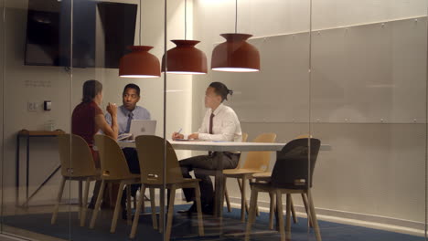 colleagues in meeting cubicle at a big corporate business