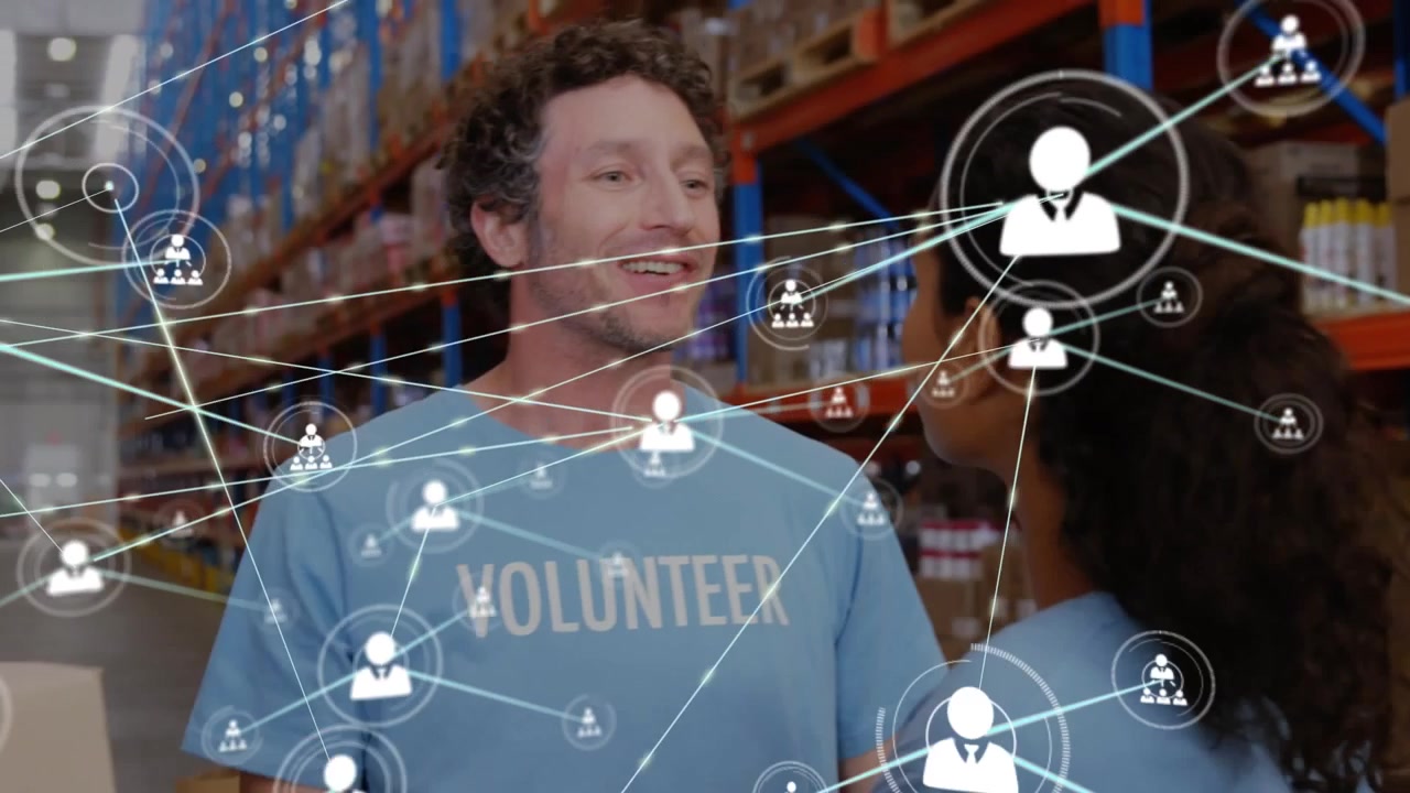 Animation of network of profile icons over diverse male and female volunteers hugging each other