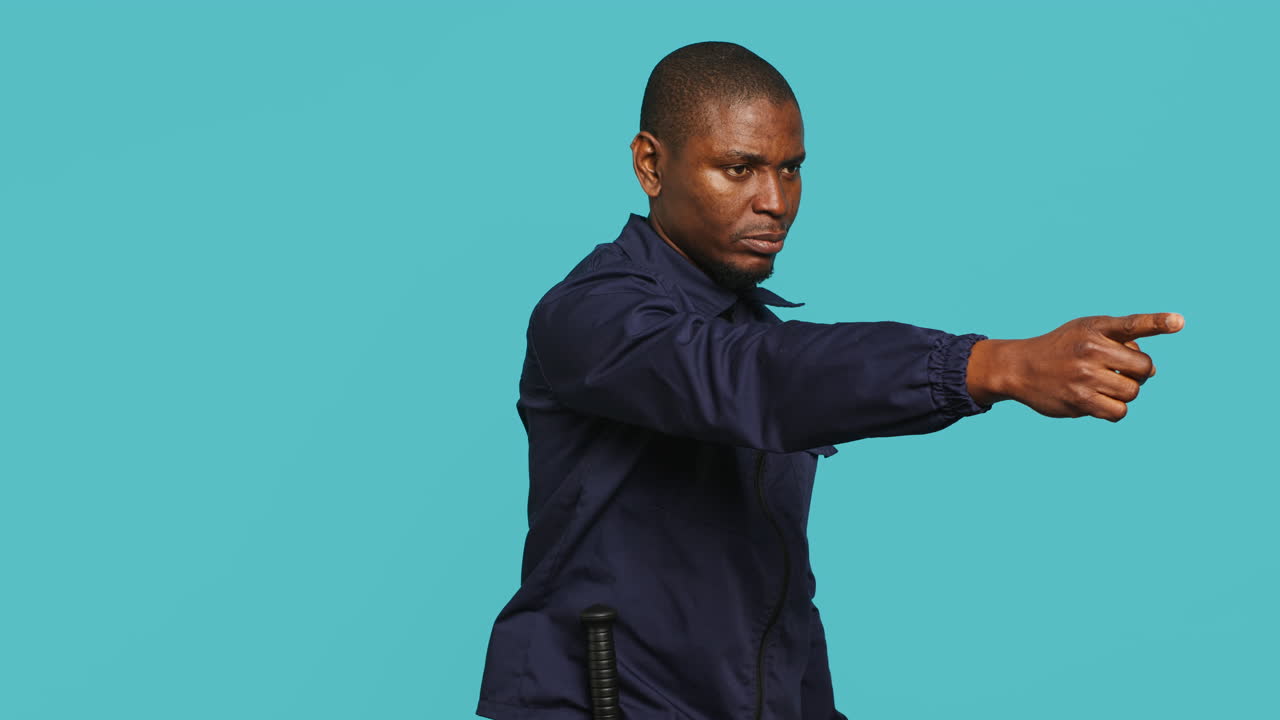 Portrait of stern bodyguard pushing back unwanted visitors