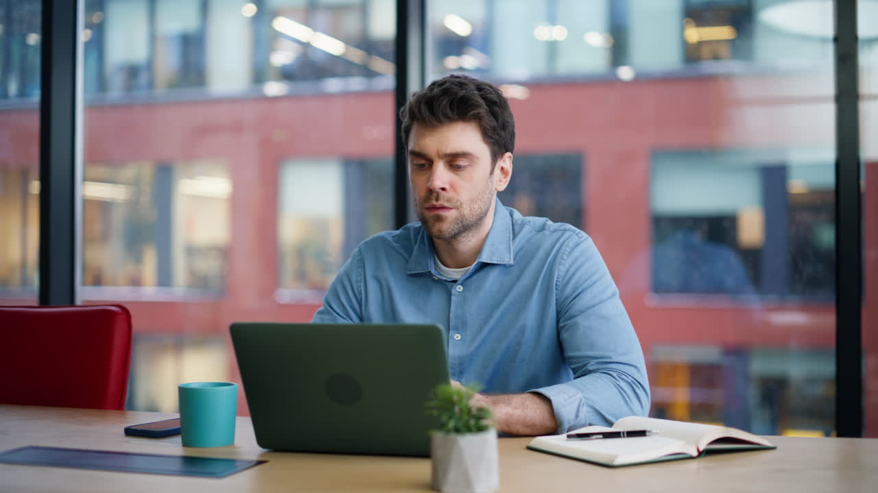 Corporate employee looking laptop thinking on project closeup. Serious man