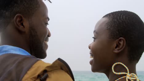 rear view of african american couple standing together o the beach 4k