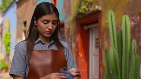 Young Woman Crafting in a Vibrant Outdoor Setting with Cacti