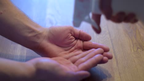 Close up of young man disinfect his hands with disinfectant.