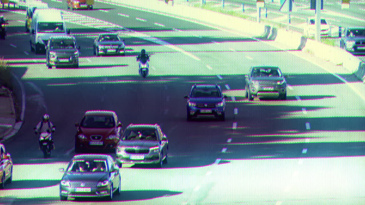 traffic on a highway in barcelona during evening rush hour with vintage CCTV overlay surveillance