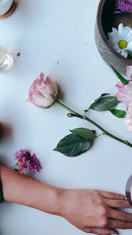 floral arrangement with tea and hands