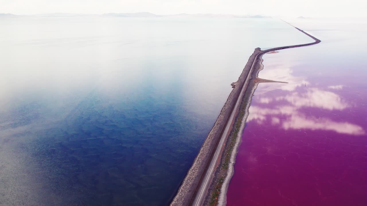 Pink and blue split of the Great Salt Lake, Utah near Promontory Point from a drone aerial perspective